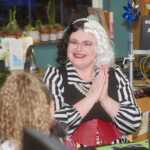 patron smiling with hands pressed together