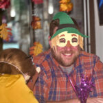 patron smiling in a halloween mask