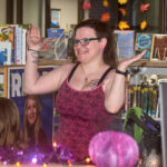 patron smiling and with hands up