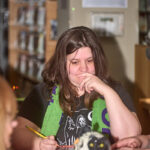 patron thinking as she writes