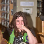 patron thinking as she writes