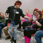 Rockstar actor retrieving items from two sitting attendees