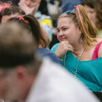 Attendee in her 80s outfit pondering