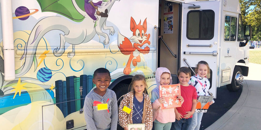 Kids in front of the Bookmobile